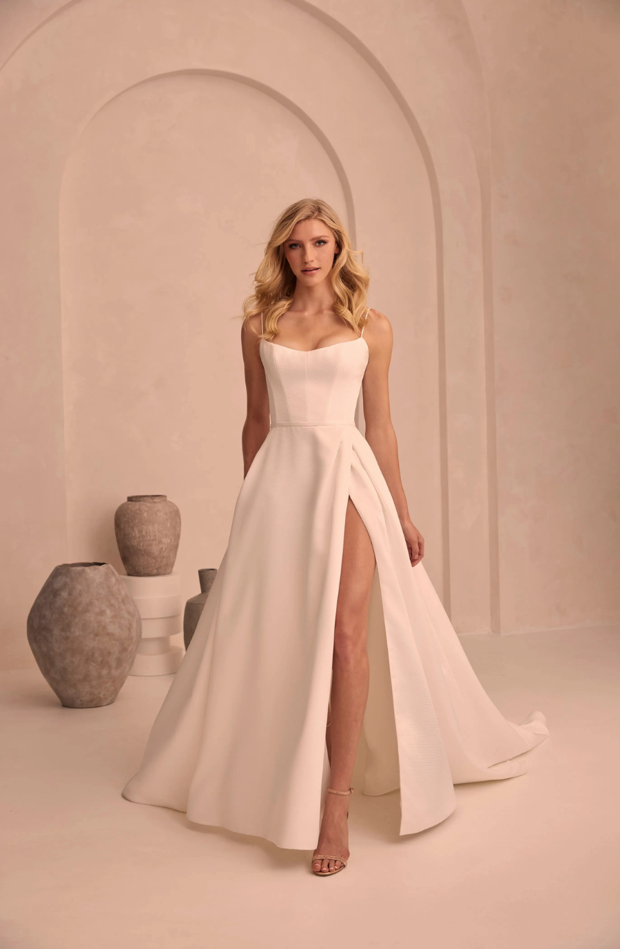 model is wearing a strapless a-line wedding dress