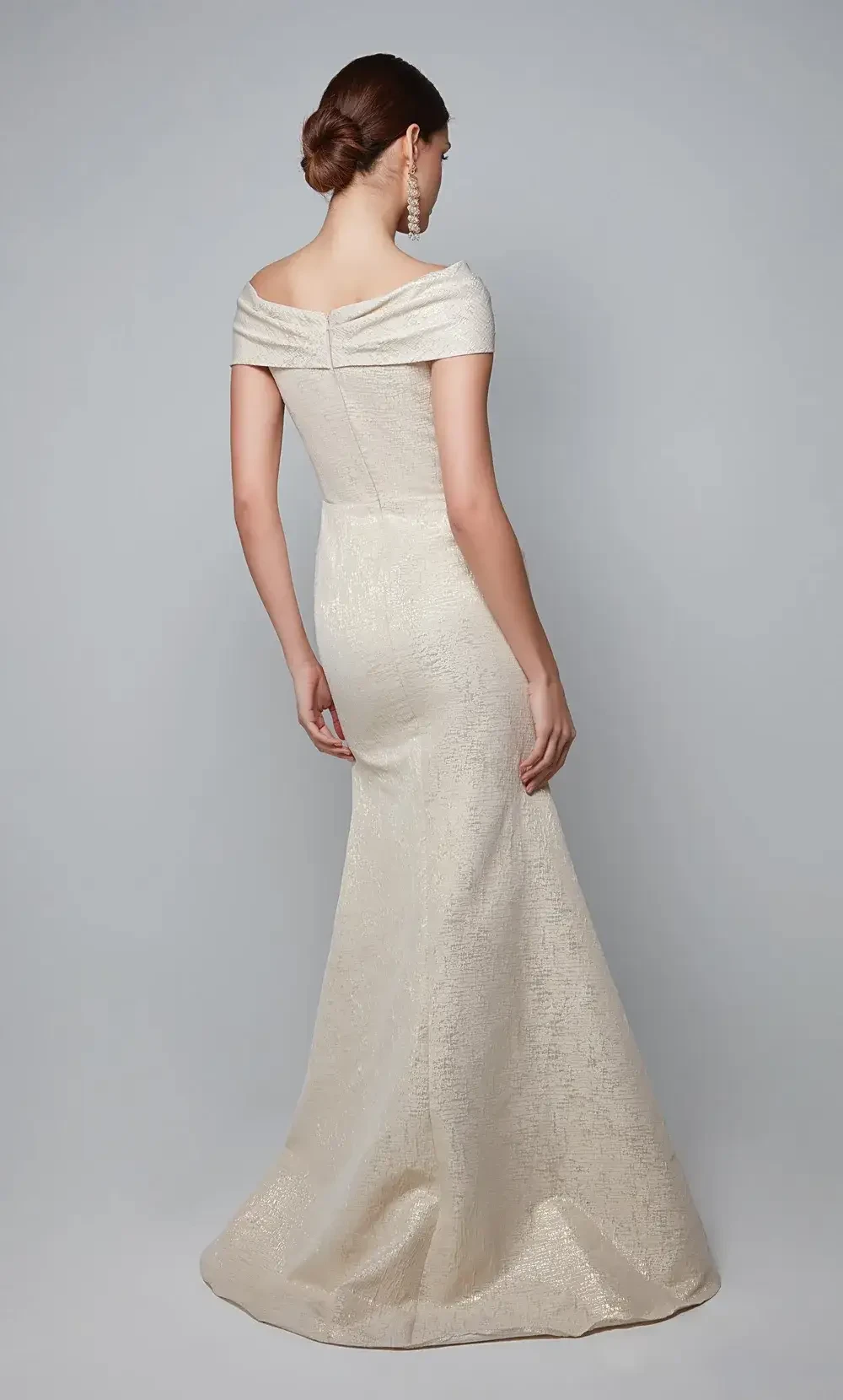 model is wearing a gold off the shoulder mothers gown