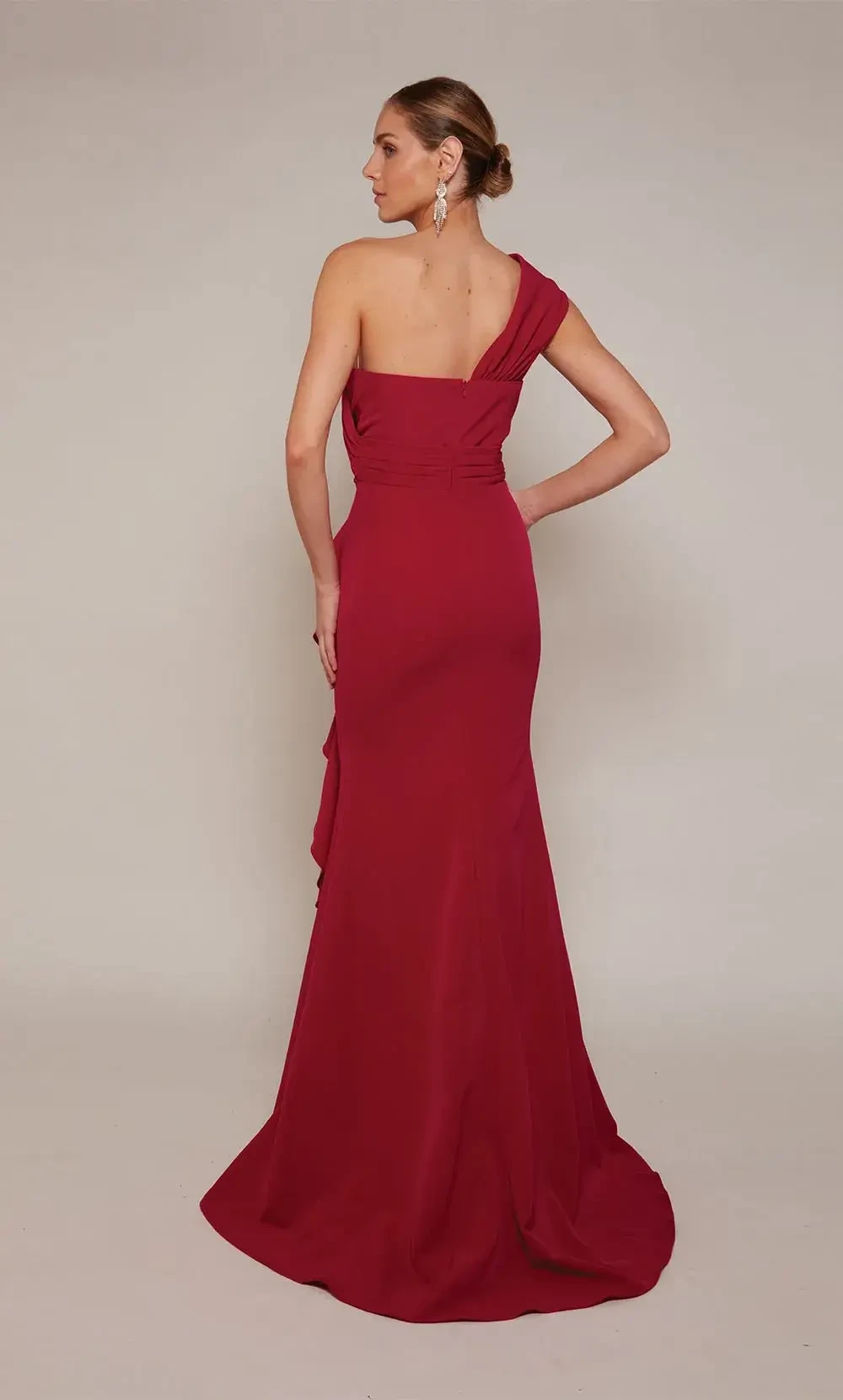 model is wearing a red one shoulder mothers gown