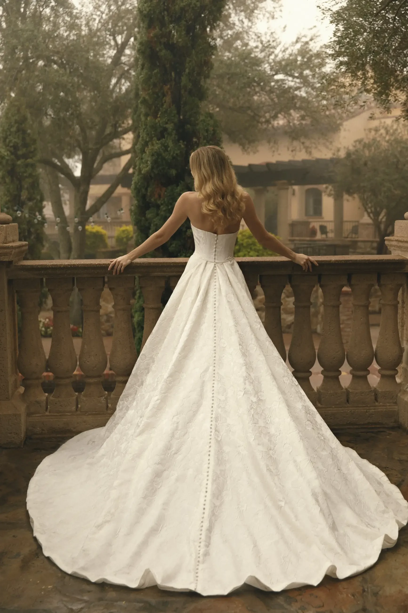 model is wearing a strapless fit and flare wedding gown