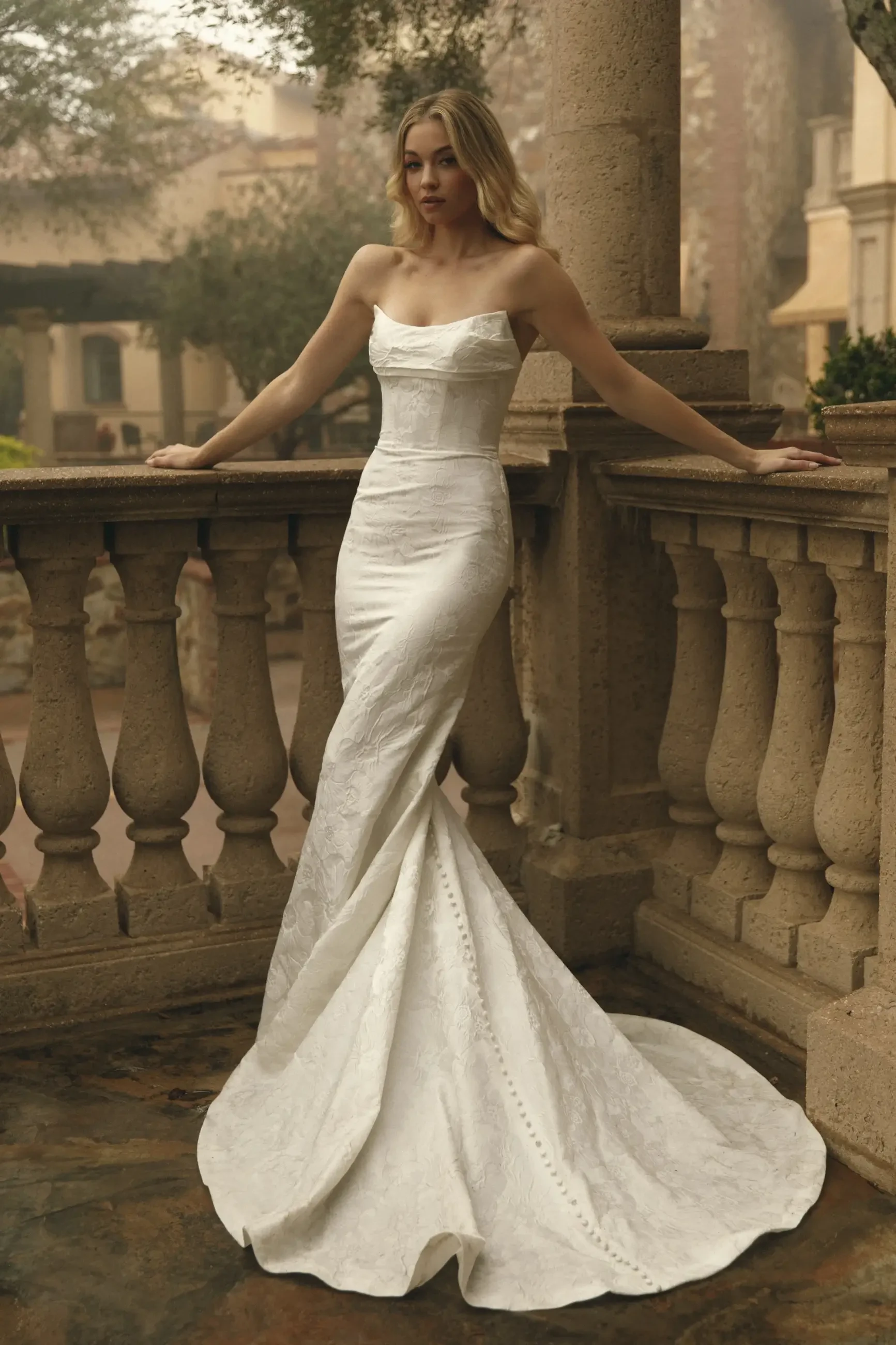 model is wearing a strapless fit and flare wedding gown