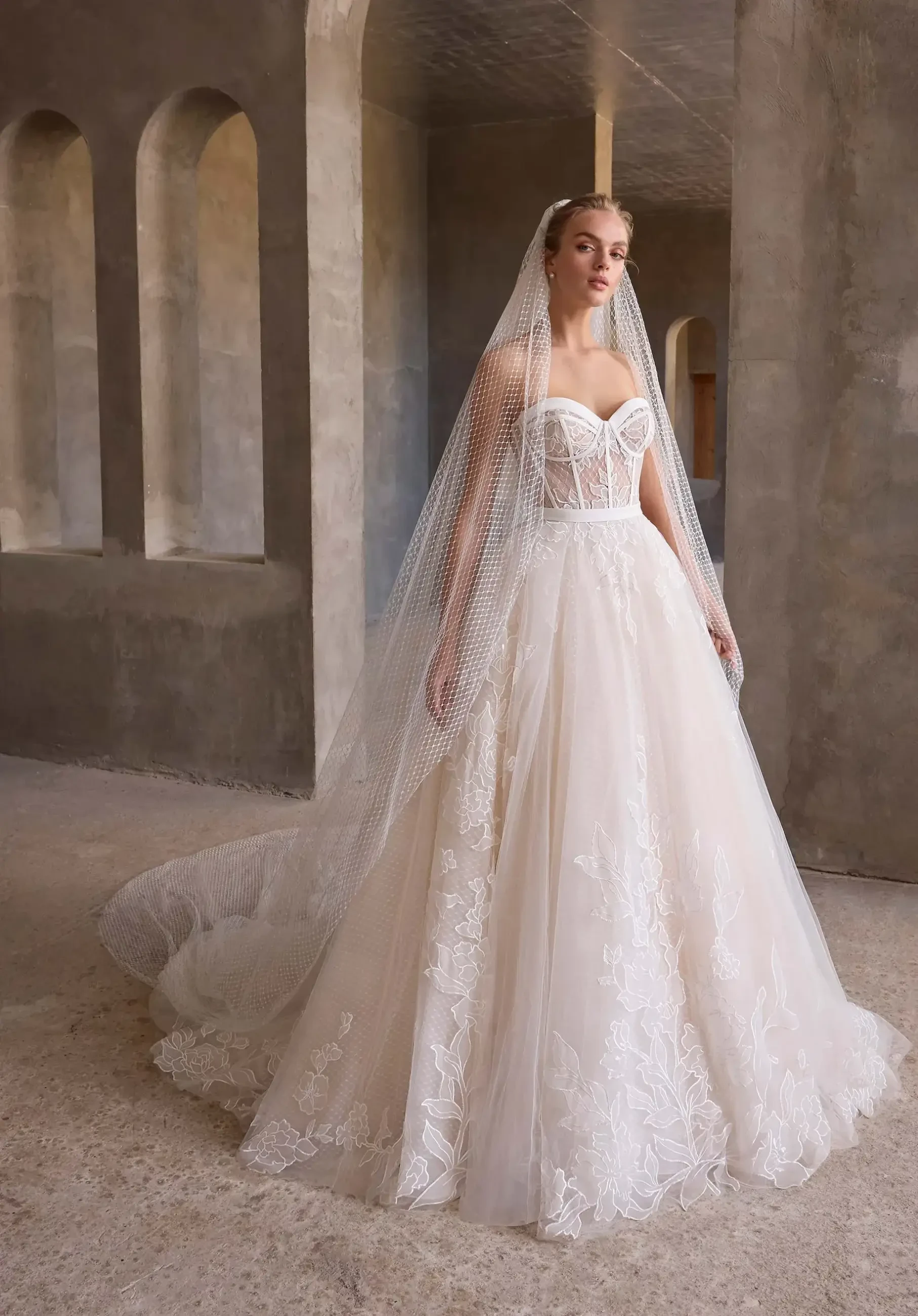 Model is wearing a wedding gown with a corset bodice that shapes and supports the figure.